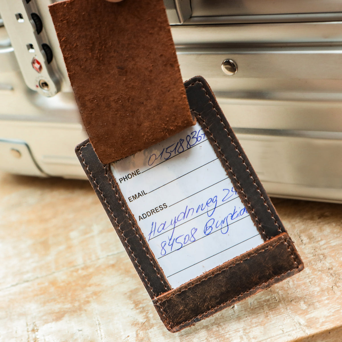 Leather luggage tag with a writable name card on travel luggage